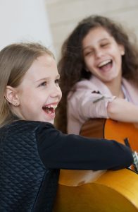 happy kids playing guitar