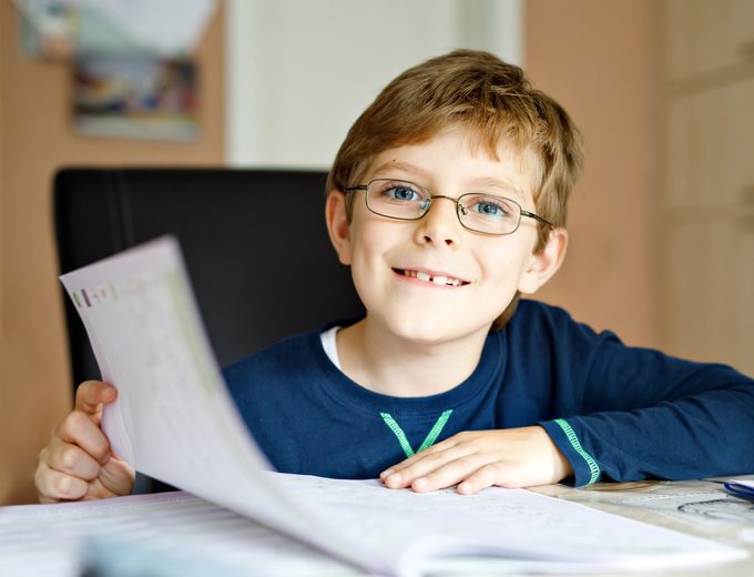 Boy at desk with book