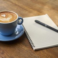 Coffee cup with notebook